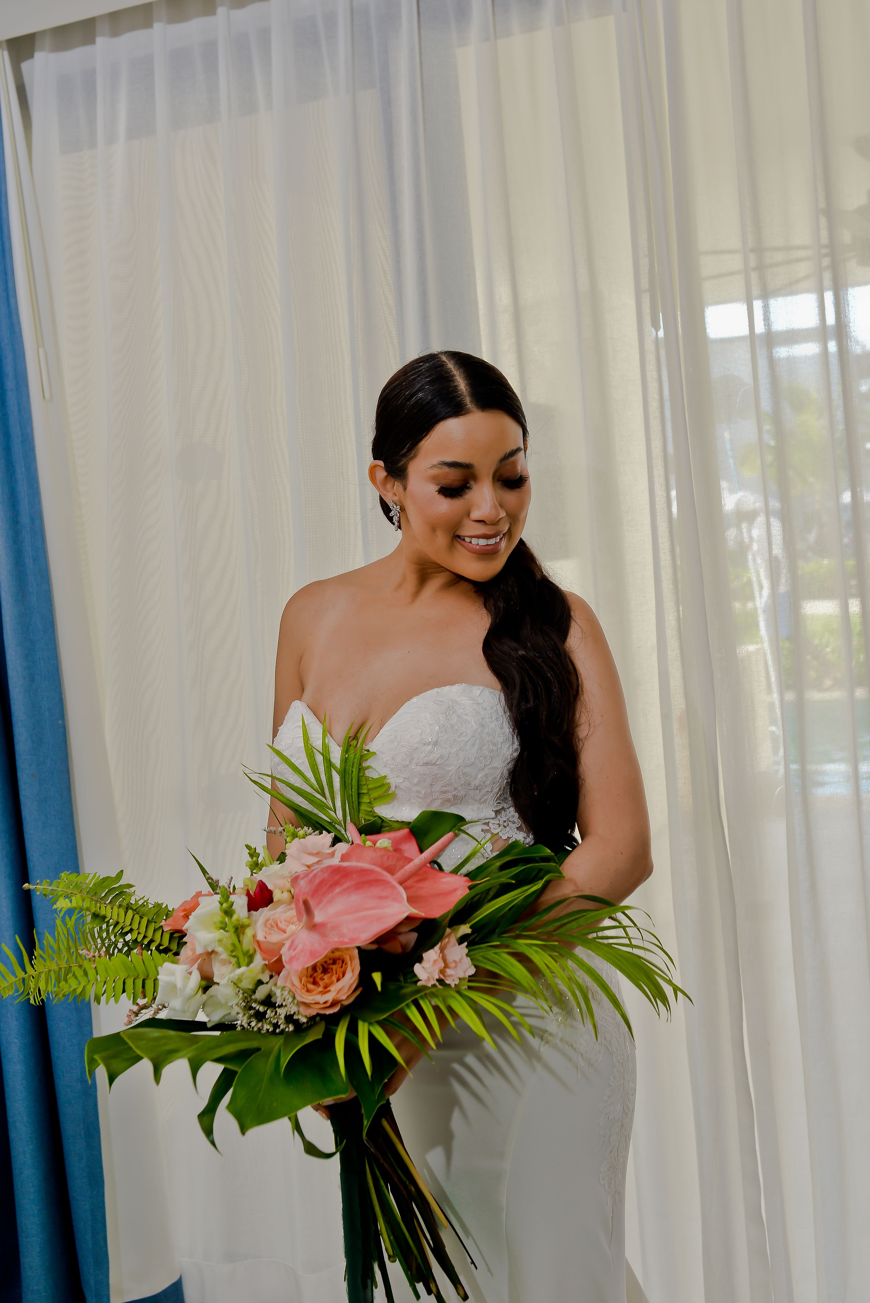 Bride holding a tropical bouquet before her Punta Cana wedding