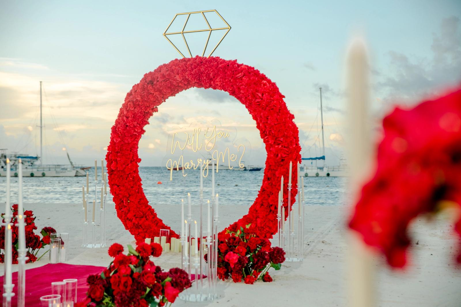 Endless Love: Horizontal view of the red floral engagement ring on the beach. Endless Love: Horizontal view of the red floral engagement ring on the beach.