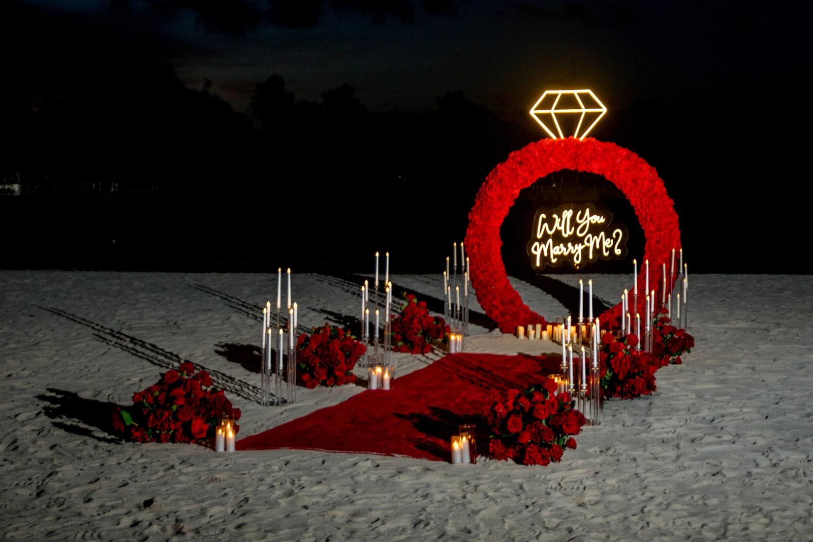 Endless Love: Illuminated red floral ring and candlelit aisle at night. Endless Love: Illuminated red floral ring and candlelit aisle at night.