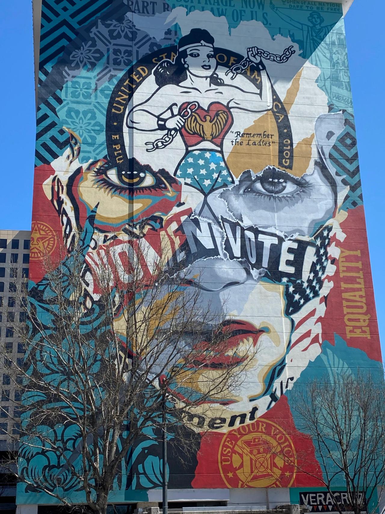 Picture of a mural from Austin, Texas. A large painting of a woman's face with a text on top saying "Women Vote".
