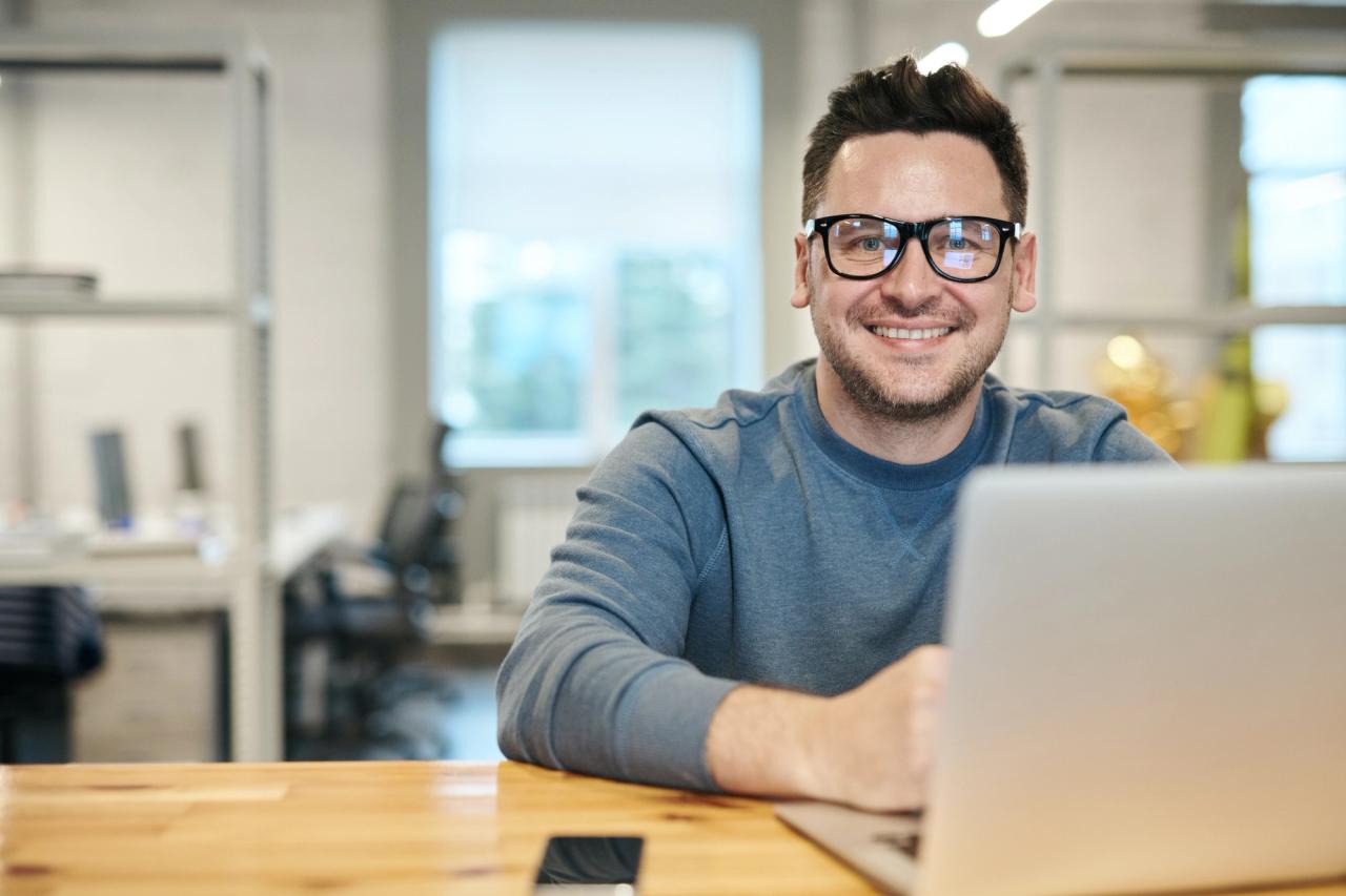 Stay sharp and energetic – happy man sits in front of computer