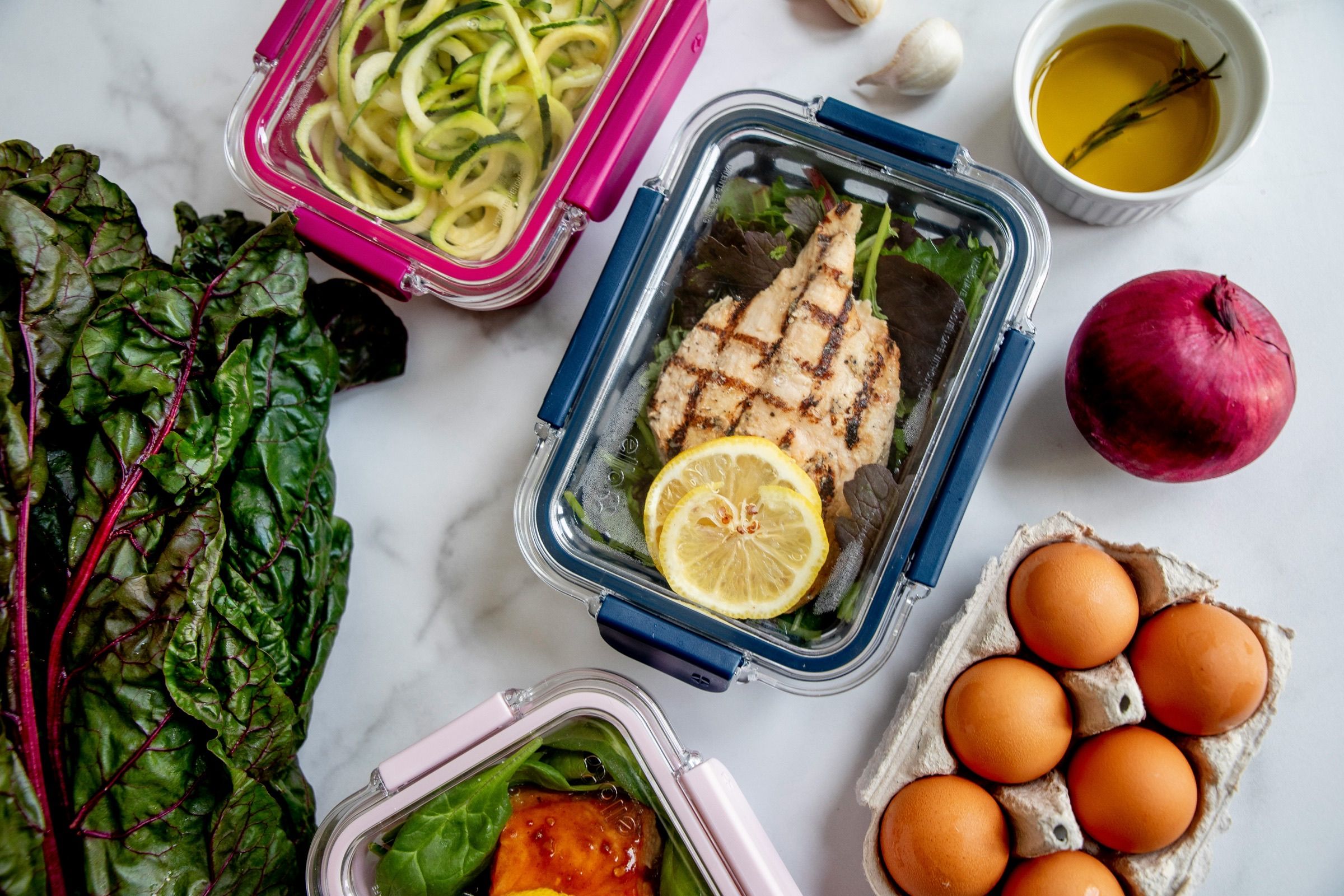 Colorful whole-food meals portioned into glass prep containers