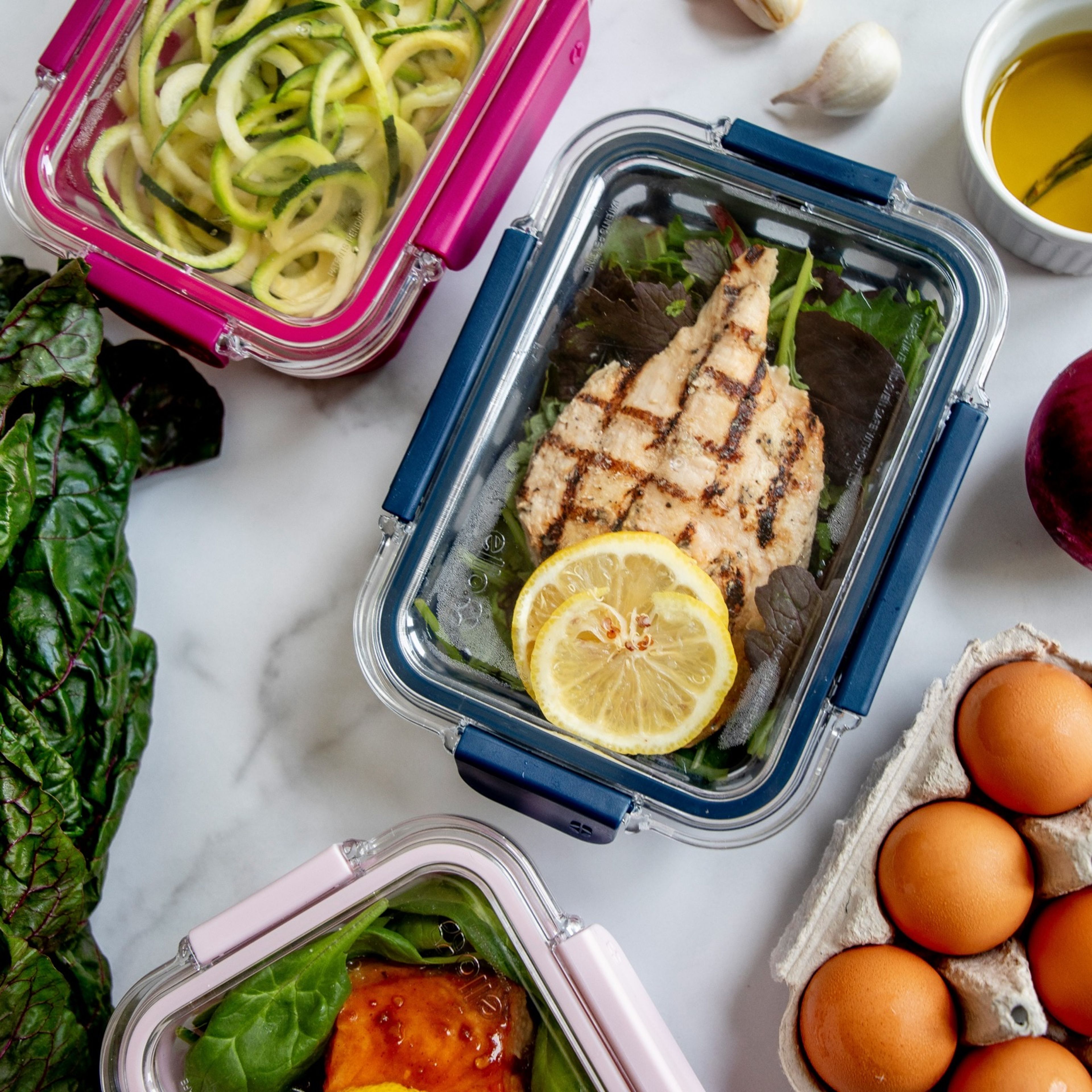 Colorful whole-food meals portioned into glass prep containers