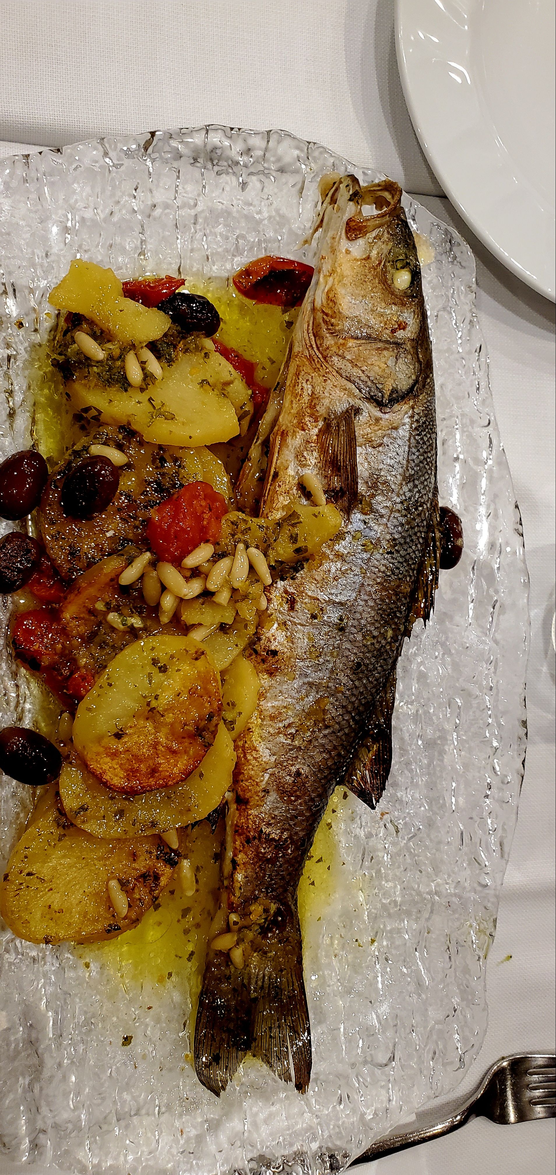 Whole roasted branzino with potatoes and olives