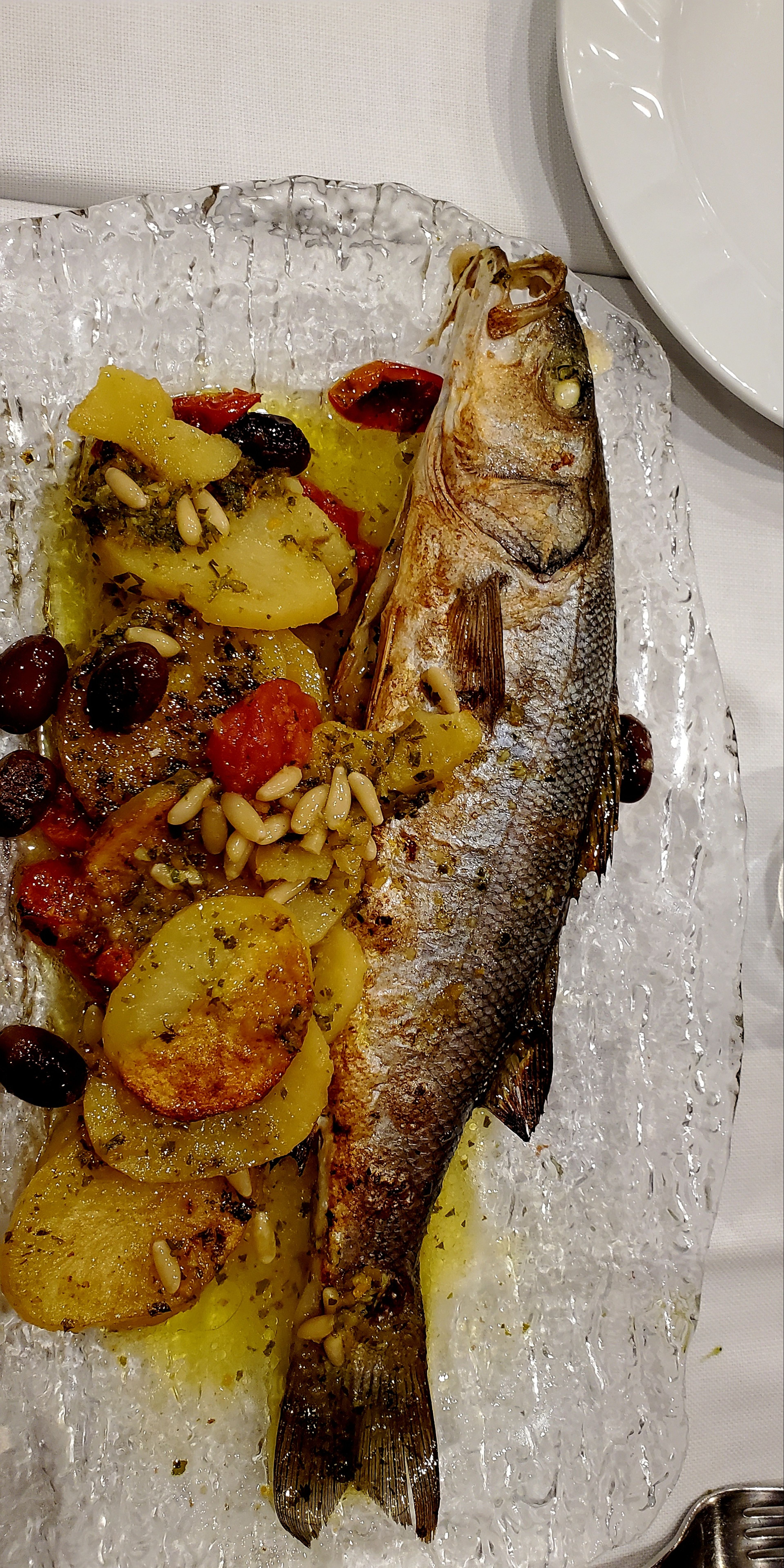 Whole roasted branzino with potatoes and olives