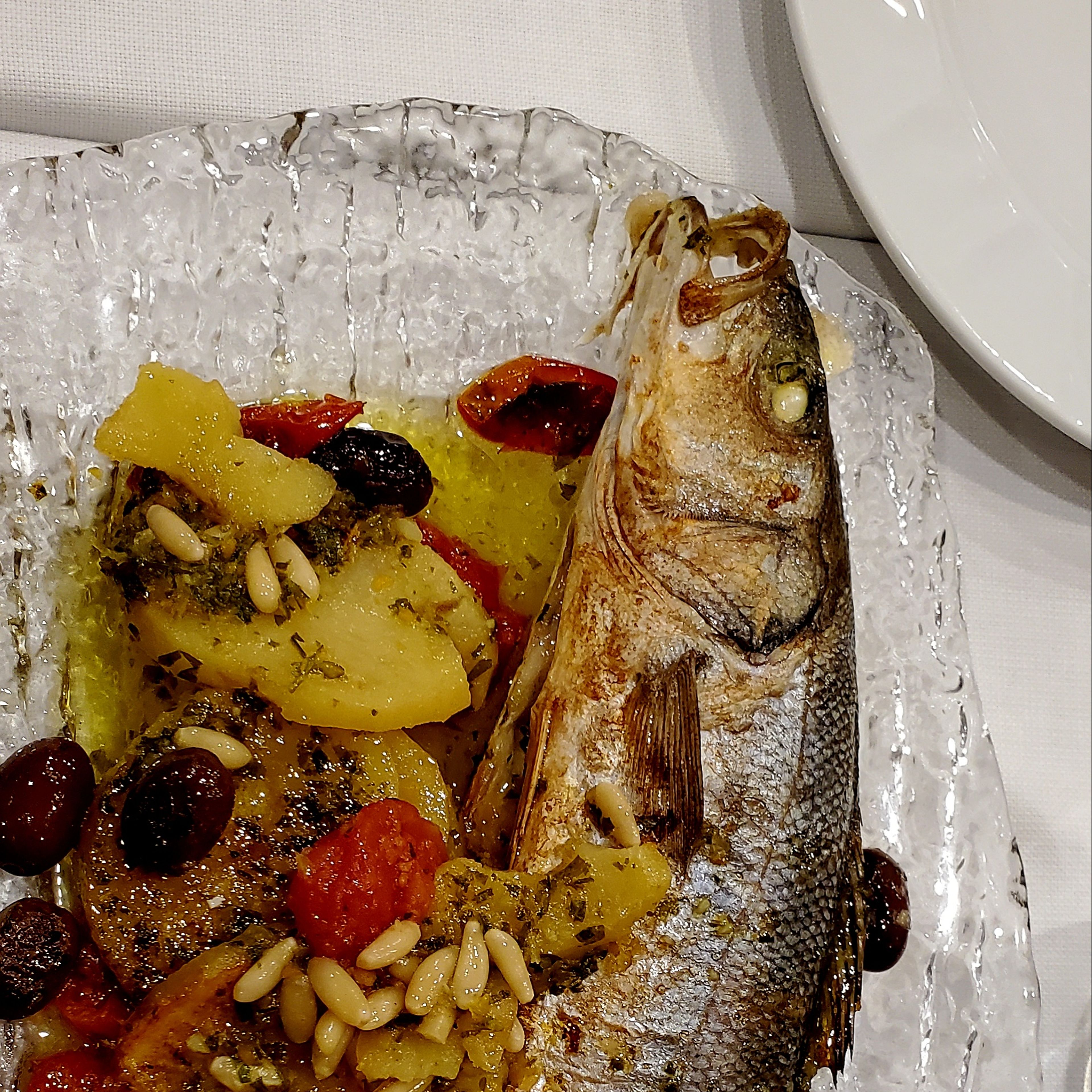 Whole roasted branzino with potatoes and olives