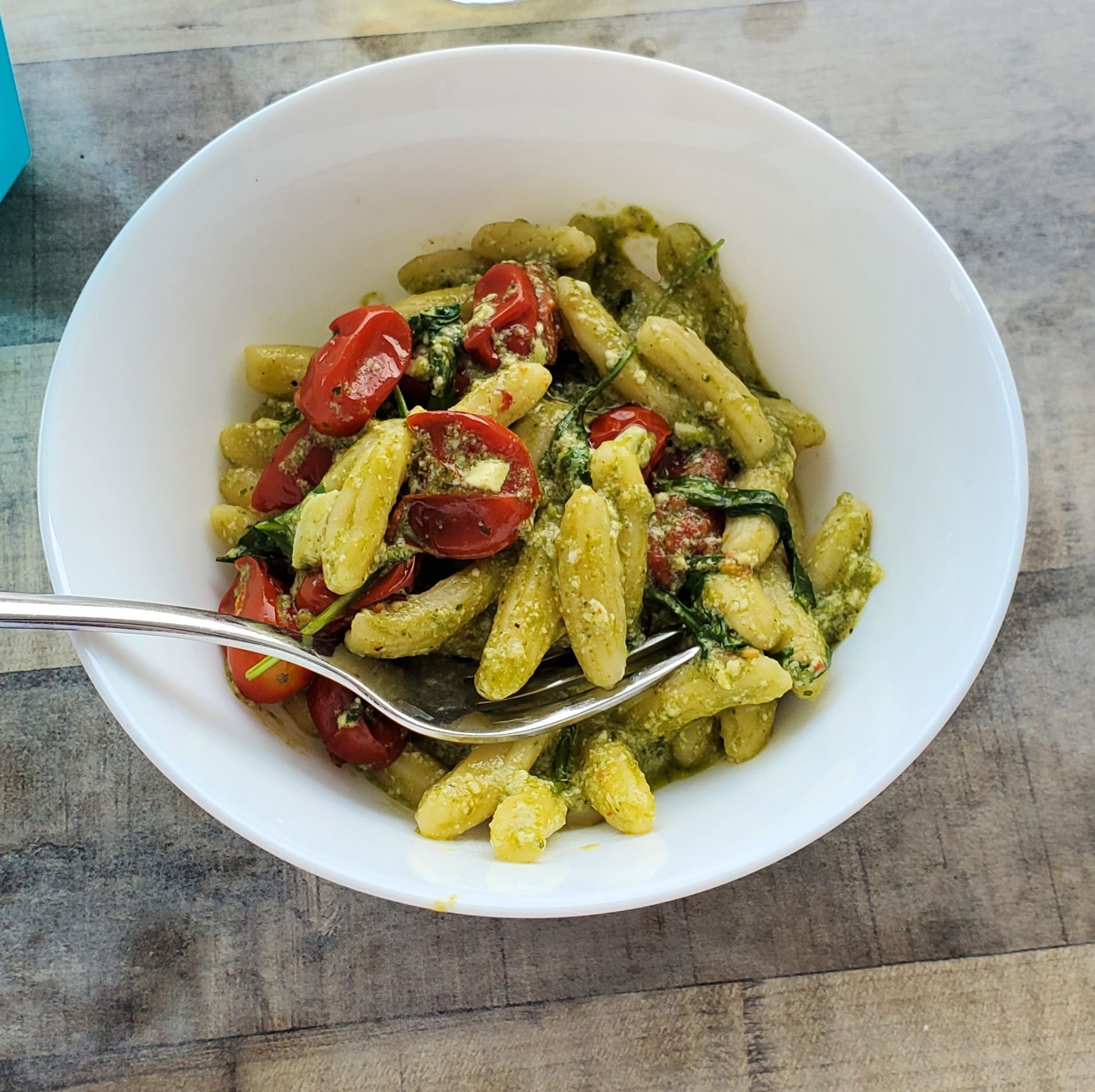 Bowl of pesto pasta with cherry tomatoes