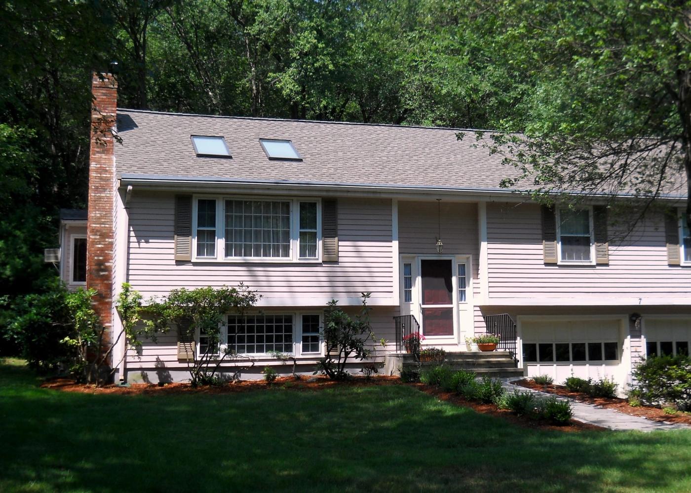 Split-level home with a newly shingled roof and two replacement skylights