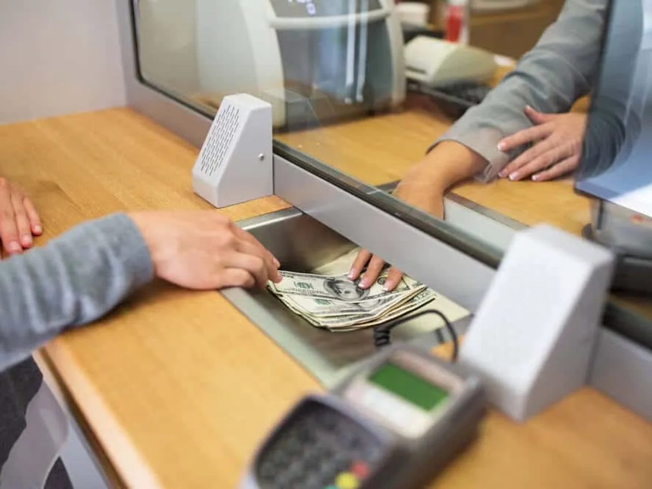 pessoa a cambiar dinheiro num banco