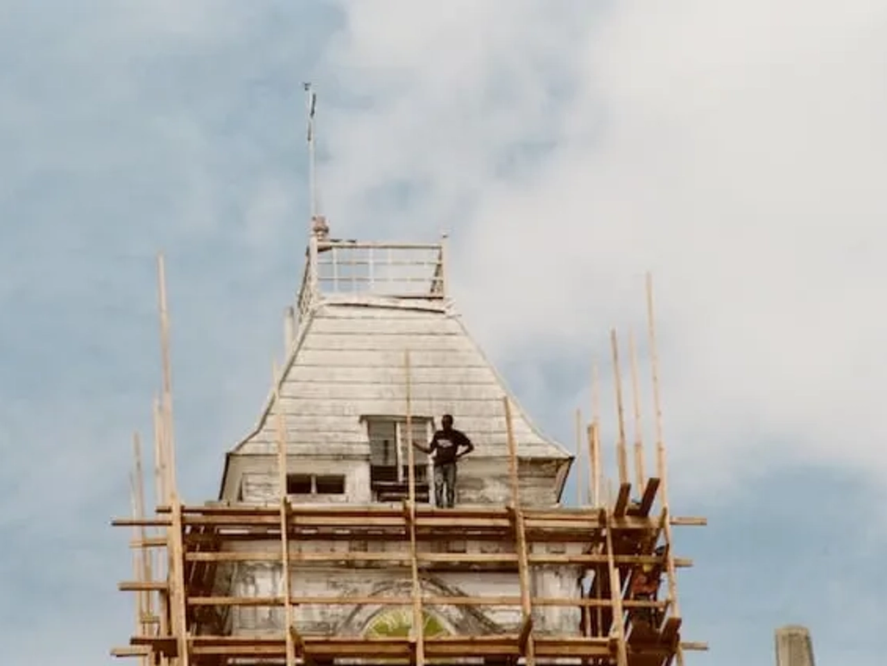 a man standing in a building in stone town, zanzibar