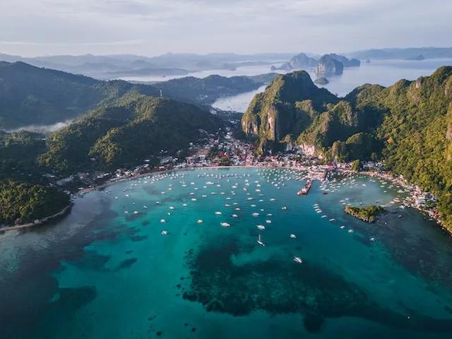 el nido in the philippines seen from above with green mountains and clear crystal waters