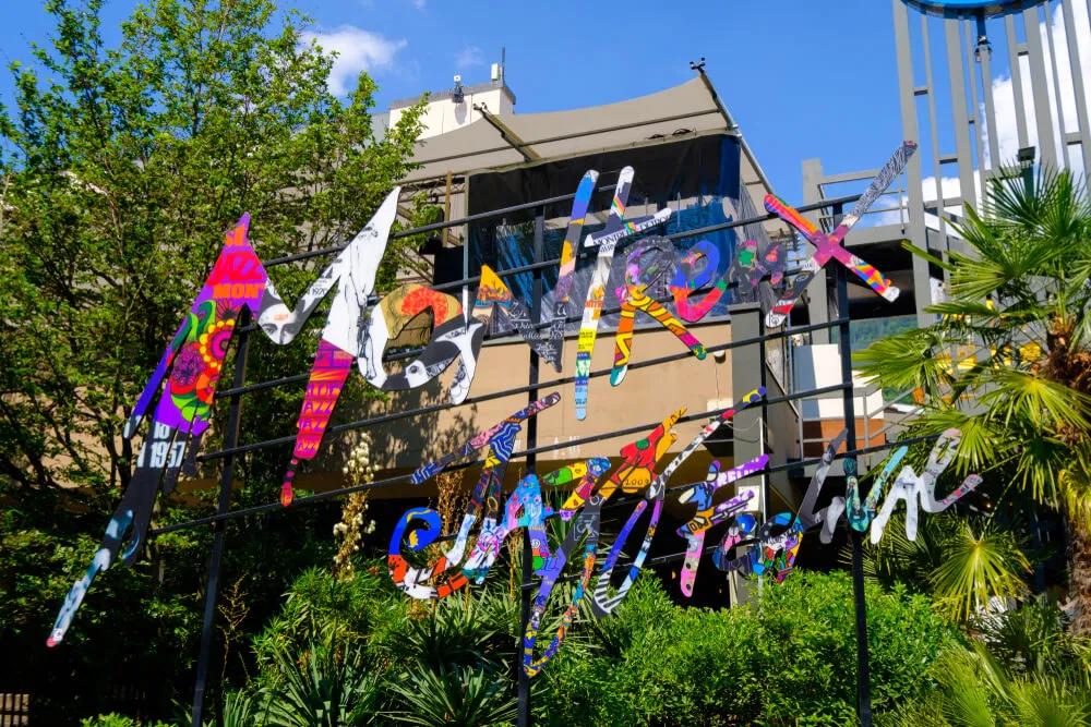 logotipo do festival de jazz pendurado numa varanda com arvores por tras