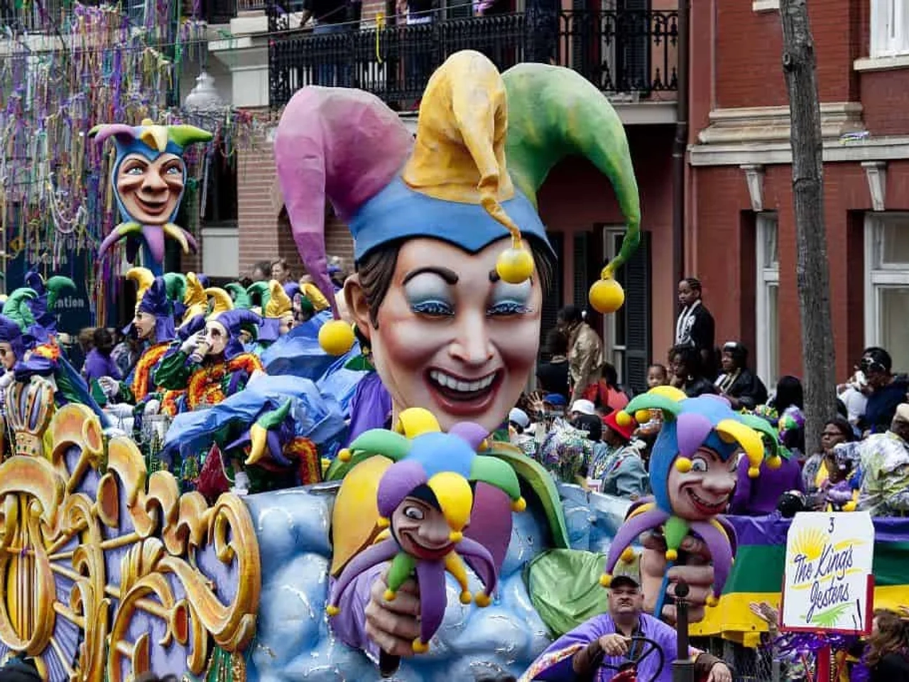 Desfile de Carnaval com grandes fantasias coloridas e personagens festivos.