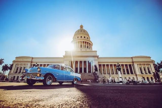 carro azul parado em frente ao capitólio em cuba