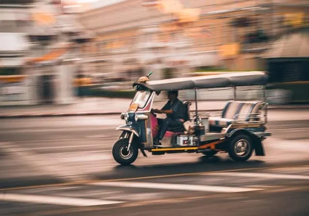 homem a conduzir um tuk tuk na tailândia