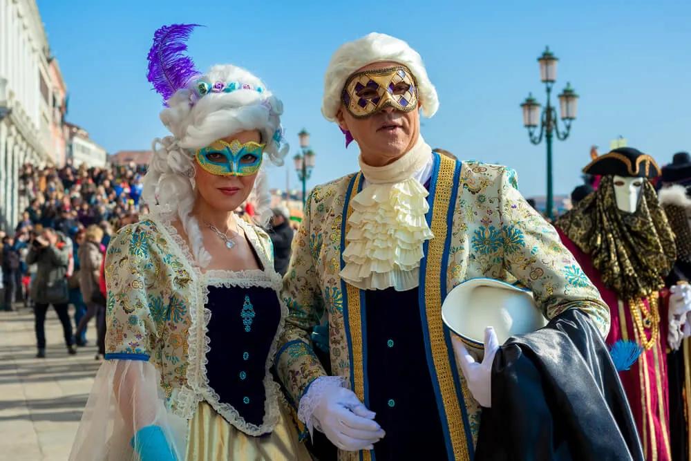 casal vestido com trajes e mascaras tipicos do carnaval de veneza