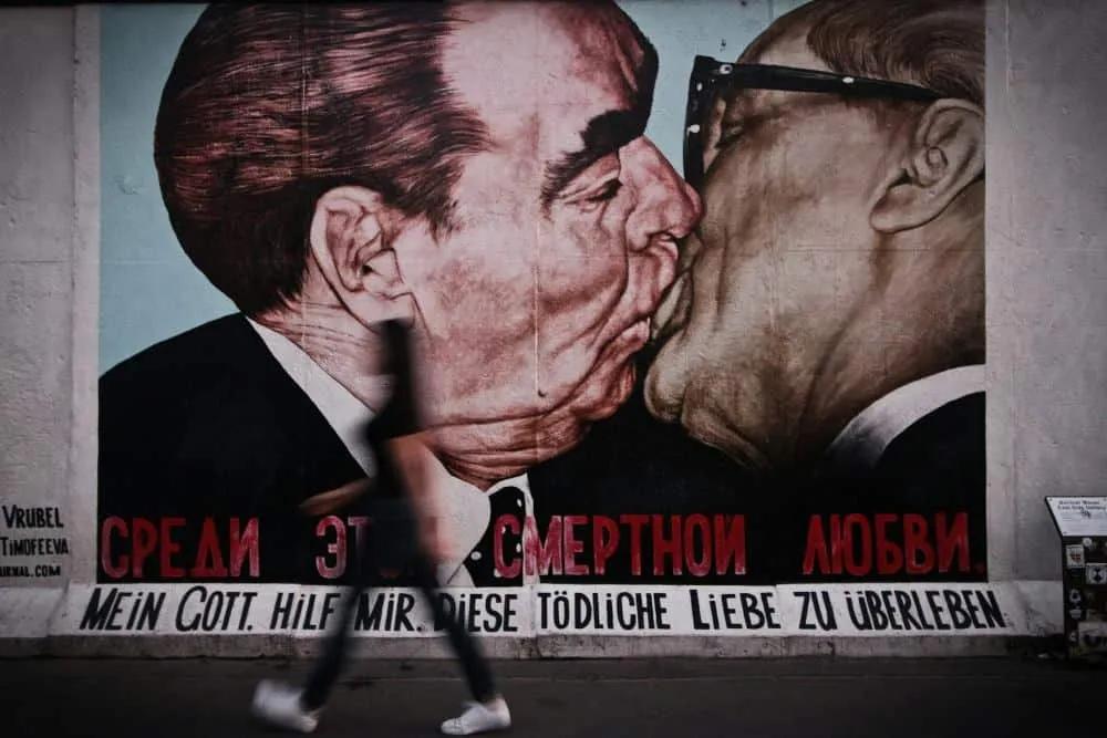 Mural icónico de Berlín que representa un beso entre líderes históricos.