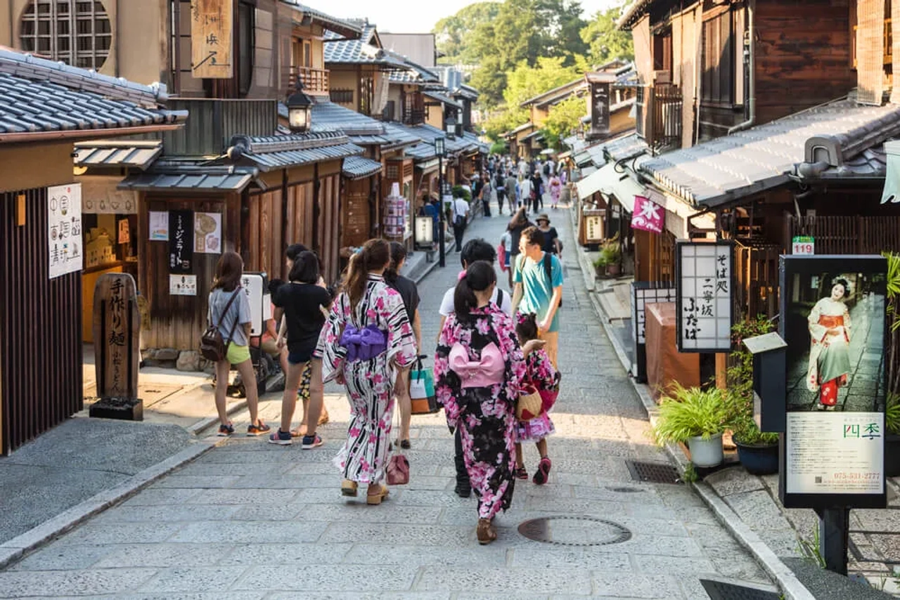 mulheres passeiam por gion vestidas com quimonos
