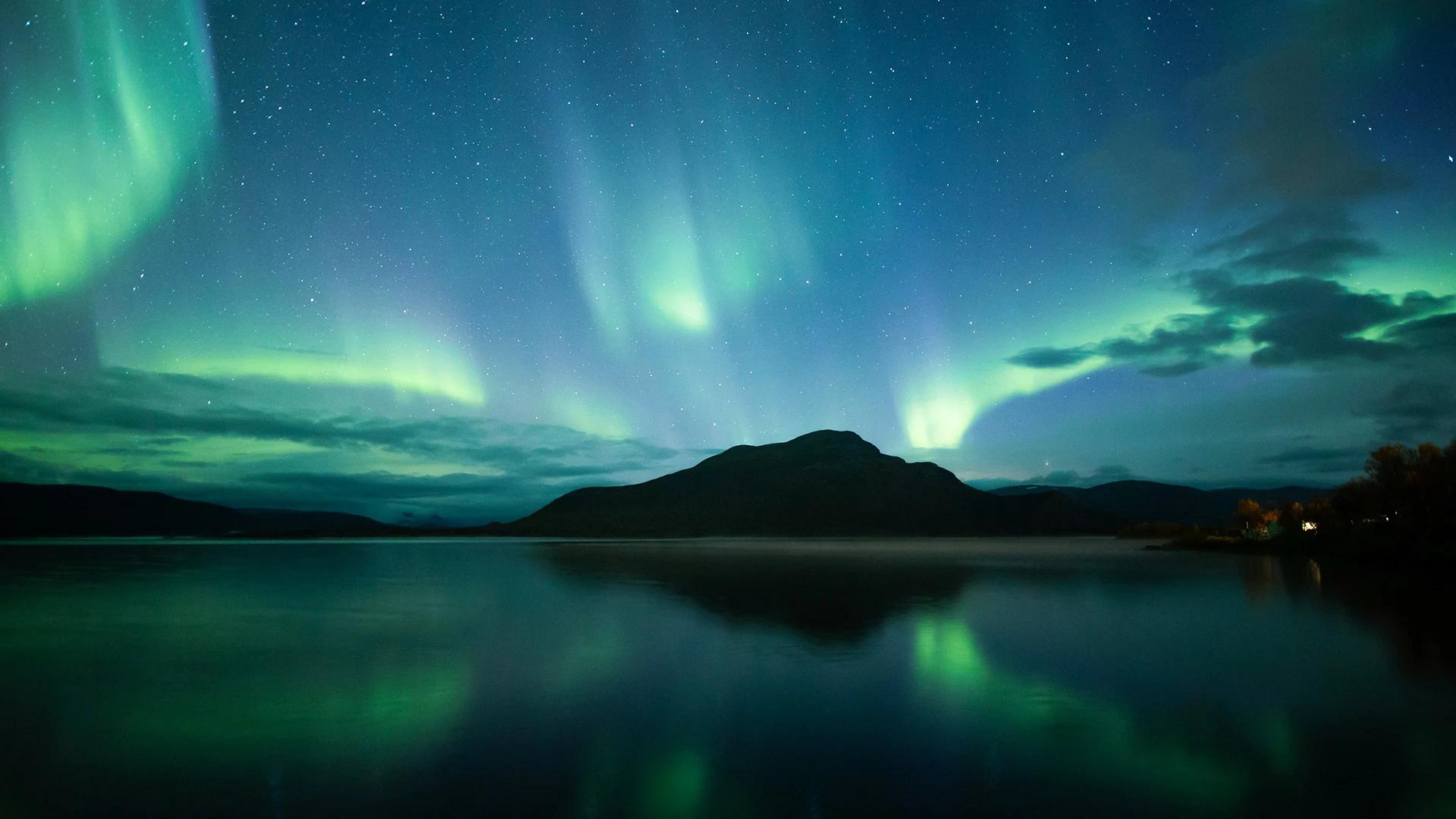 una aurora boreal sobre un lago de laponia