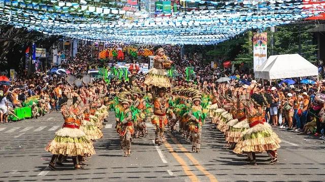 people dancing in the street wearing typical costumes form the philippines in cebu