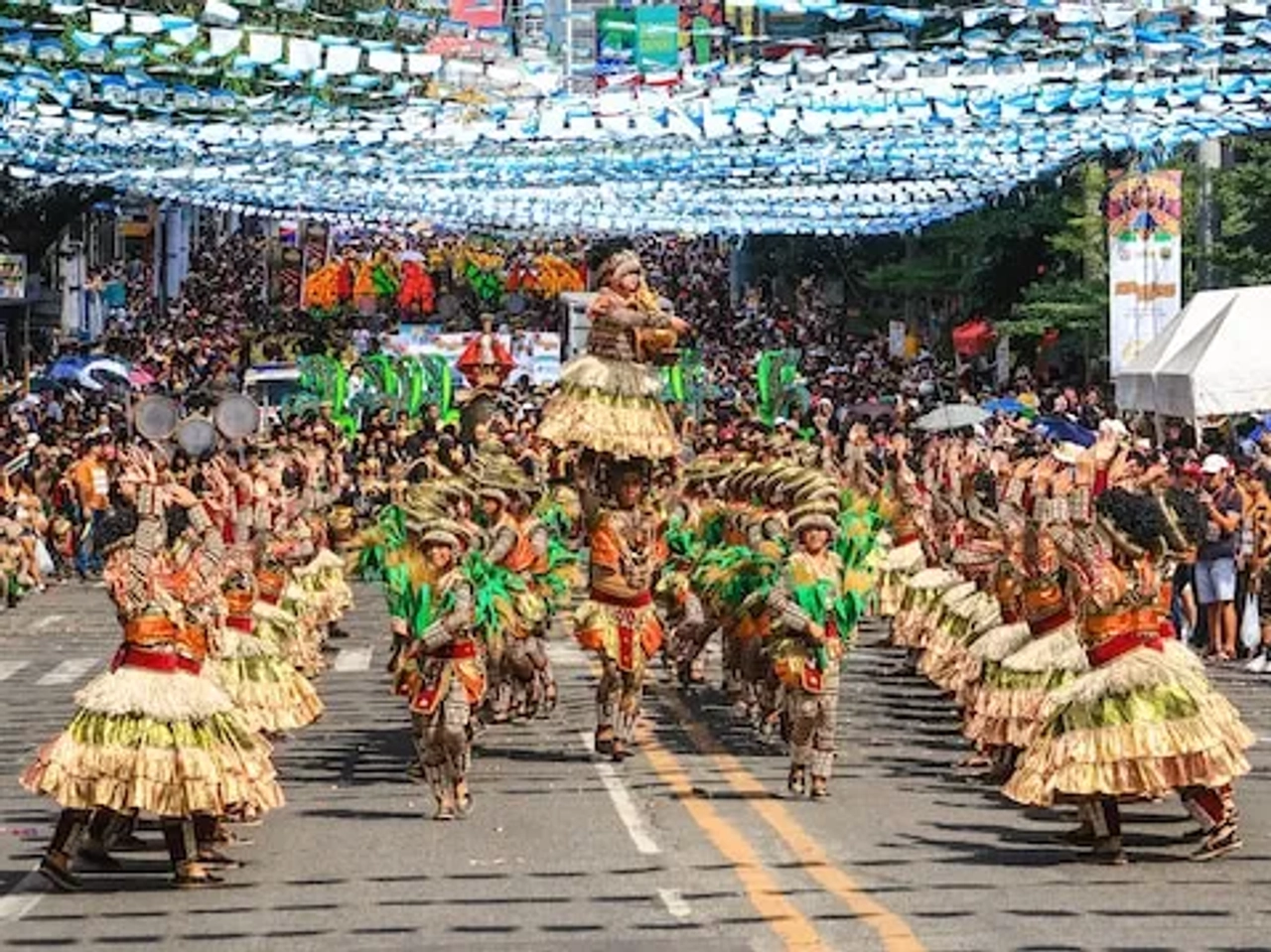 people dancing in the street wearing typical costumes form the philippines in cebu