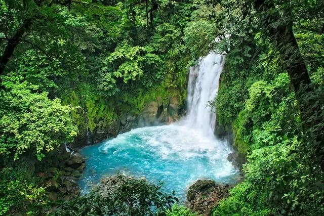 waterfall between green mountains in Volcán Tenorio, Guanacaste Province, Costa Rica