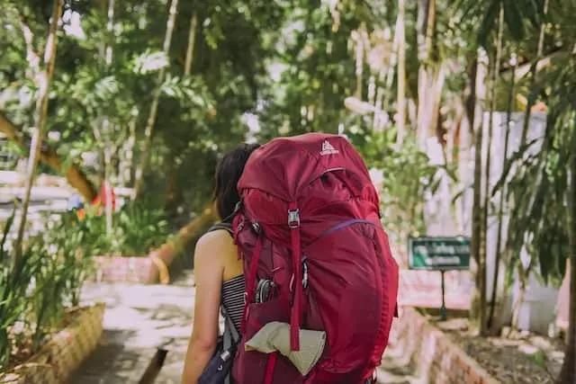 women with a red bagpack travelling
