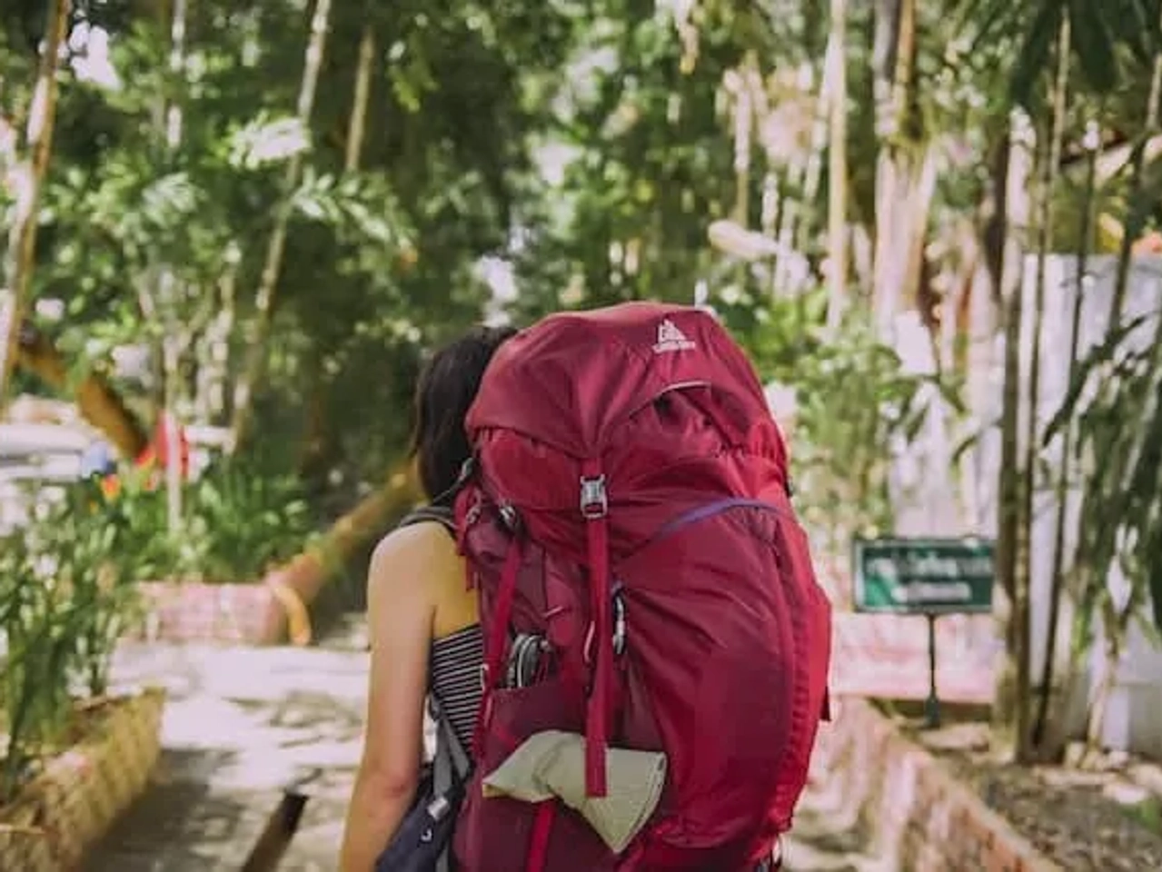 women with a red bagpack travelling