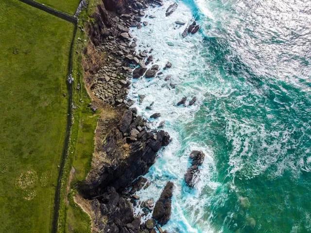 costa da Península de Dingle vista de cima com ondas a bater nas rochas