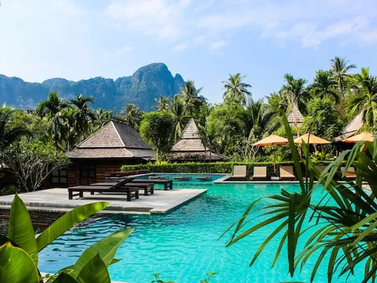 palm trees and houses in a villa resort in thailand