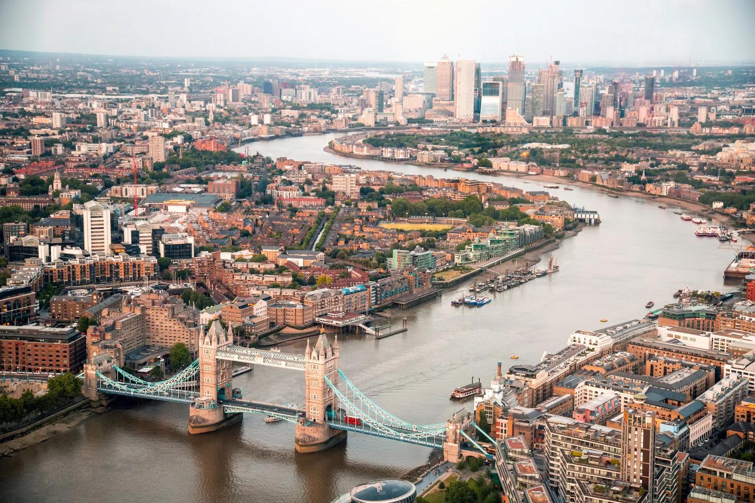 Aerial view of London, featuring the Tower Bridge and the River Thames.