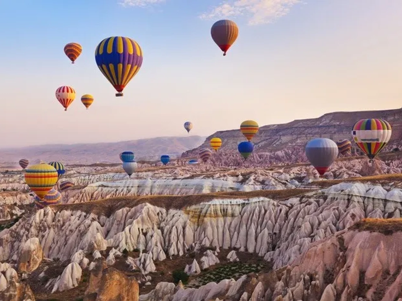 Globos aerostáticos sobre paisajes únicos de Capadocia, Turquía, al amanecer.