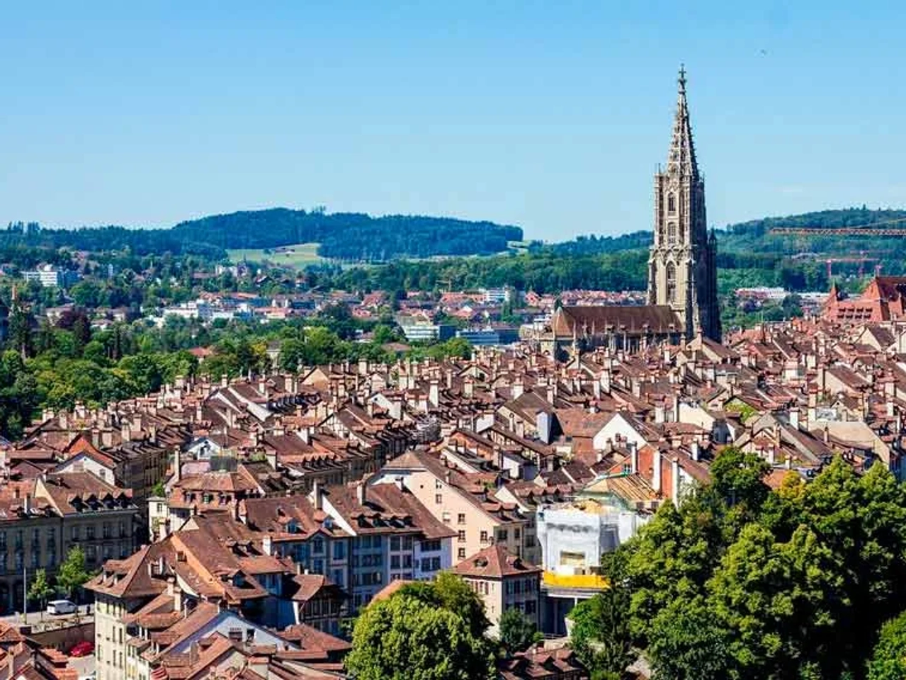 Vista panorâmica de Berna, Suíça, com telhados e a torre da catedral.