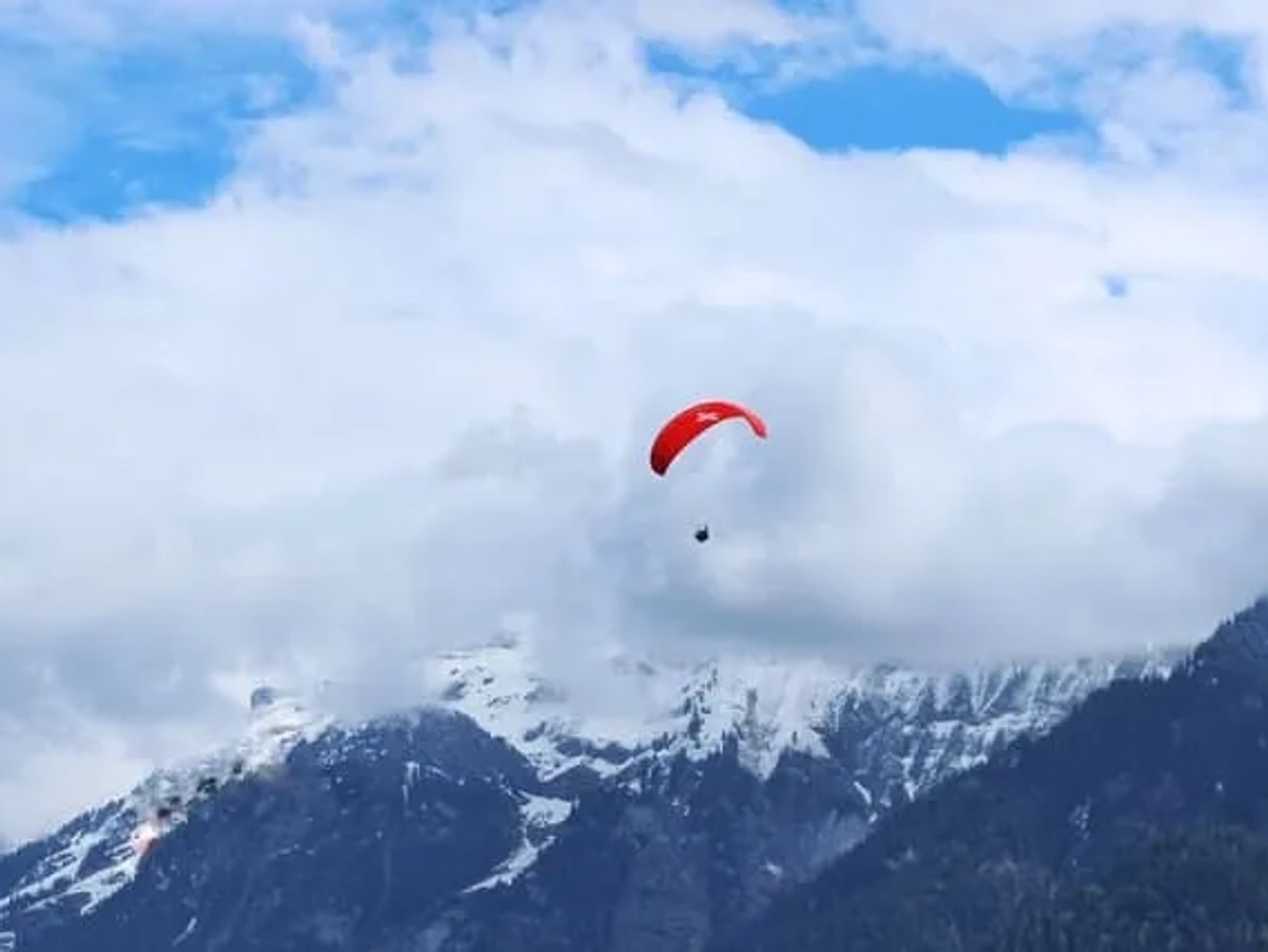 pessoa em paraquedas vermelho na suiça