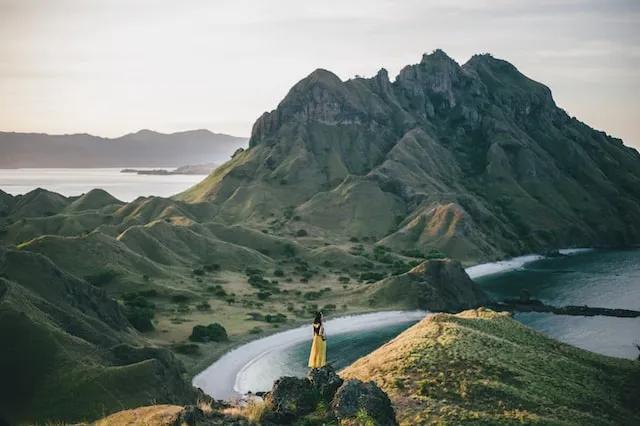 woman standing in a mountain in front of the sea in indonesia