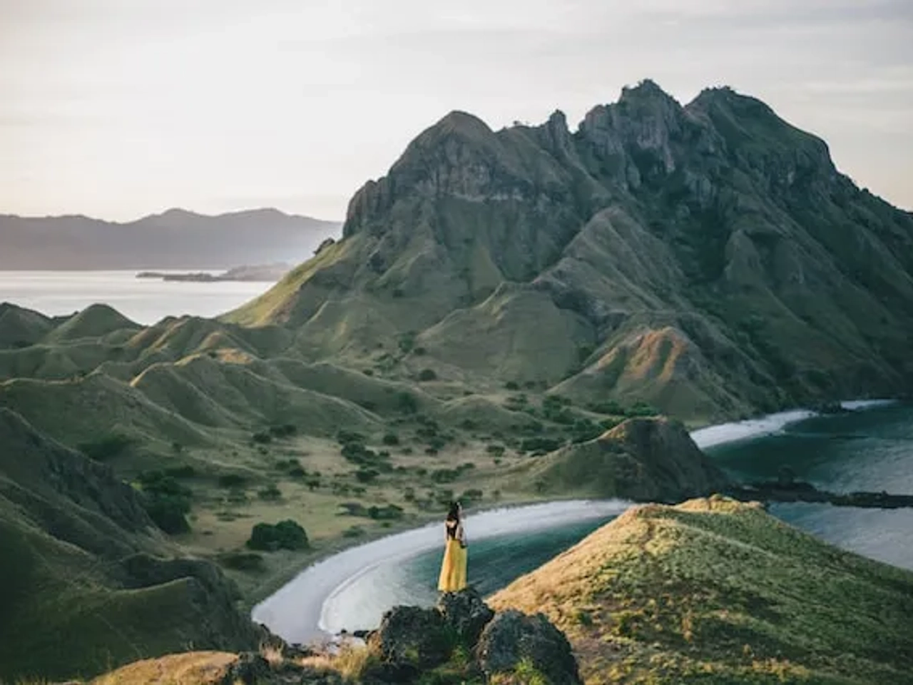 woman standing in a mountain in front of the sea in indonesia