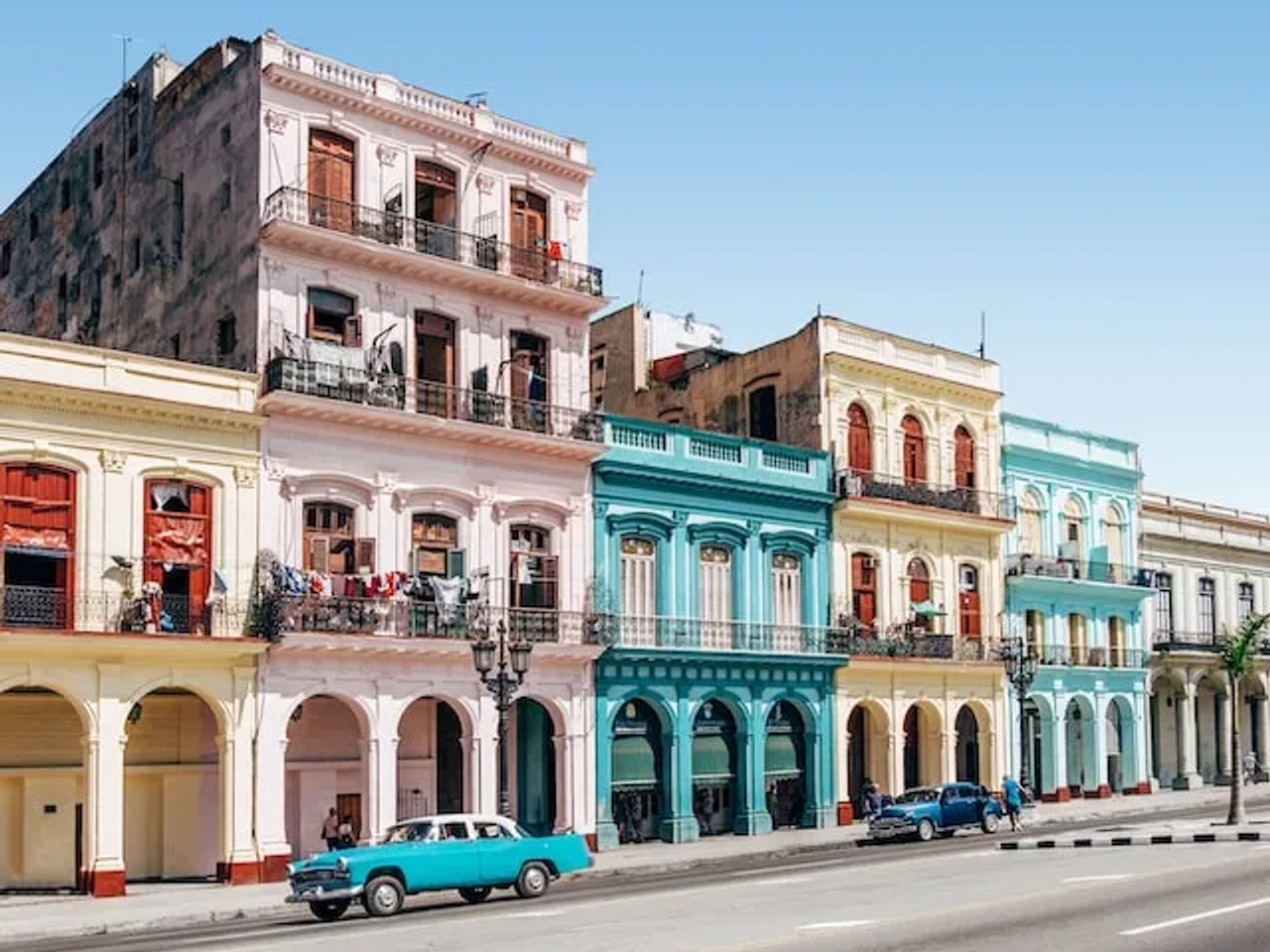 colorful houses and a car on a street in cuba