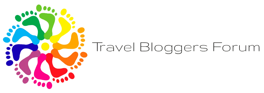 Logo colorido del Travel Bloggers Forum con huellas de pies.