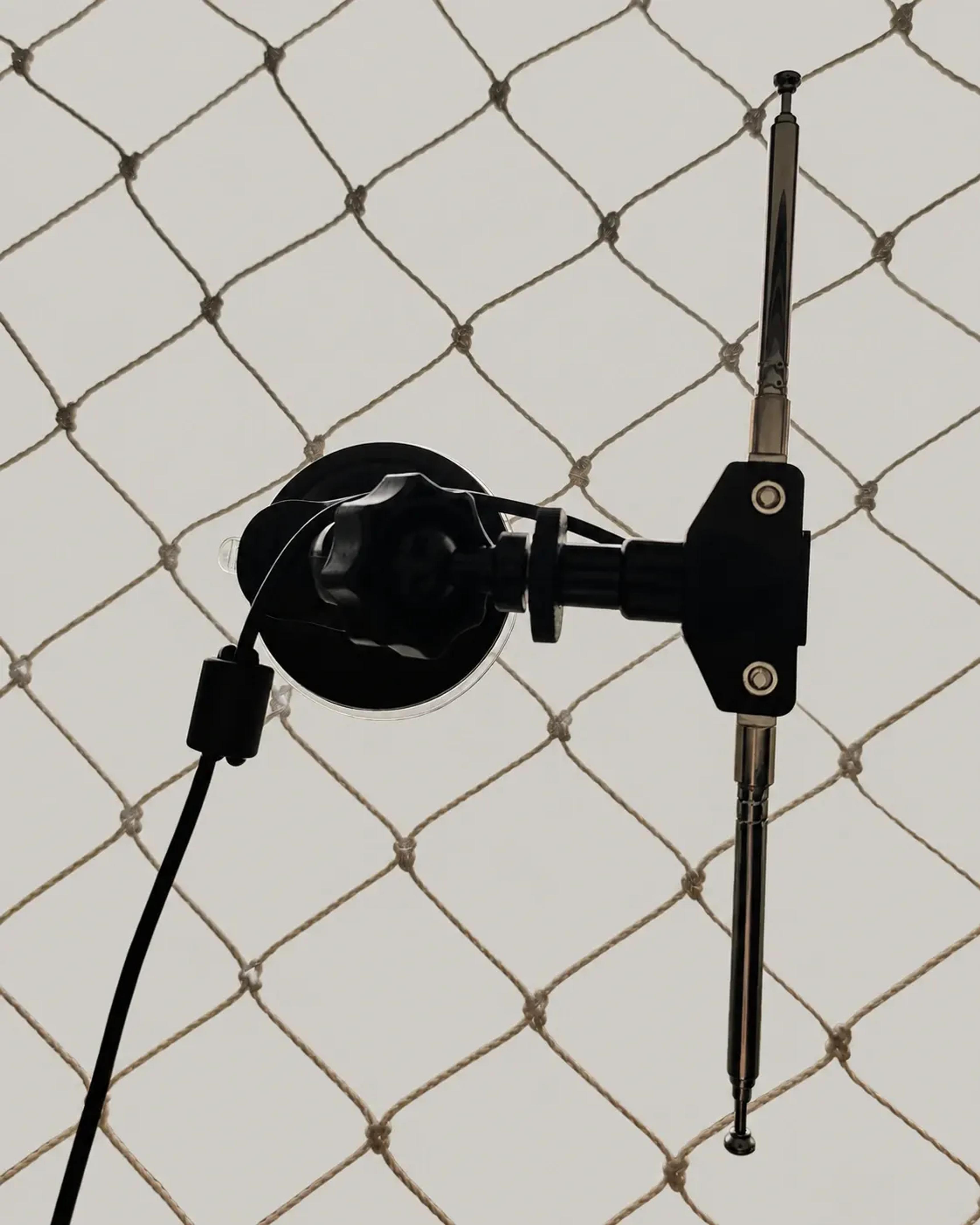 Antena dipolo telescópica presa por ventosa à janela, com o entorno externo removido