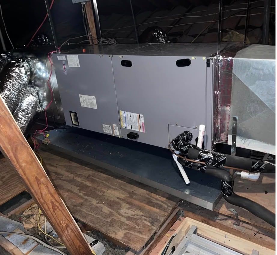 Attic air handler serviced during a maintenance visit