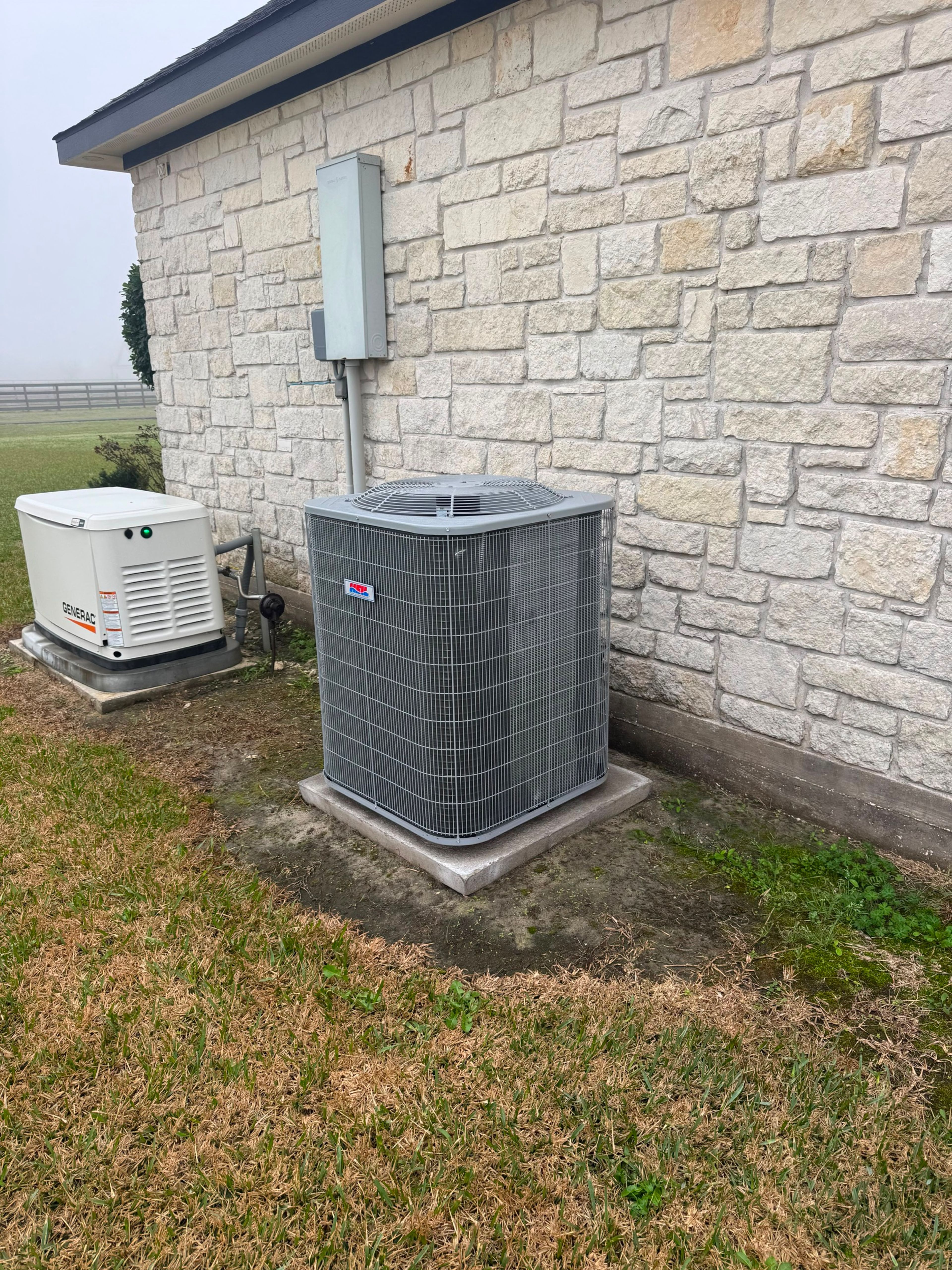 Residential condenser and standby generator installed at a Texas home
