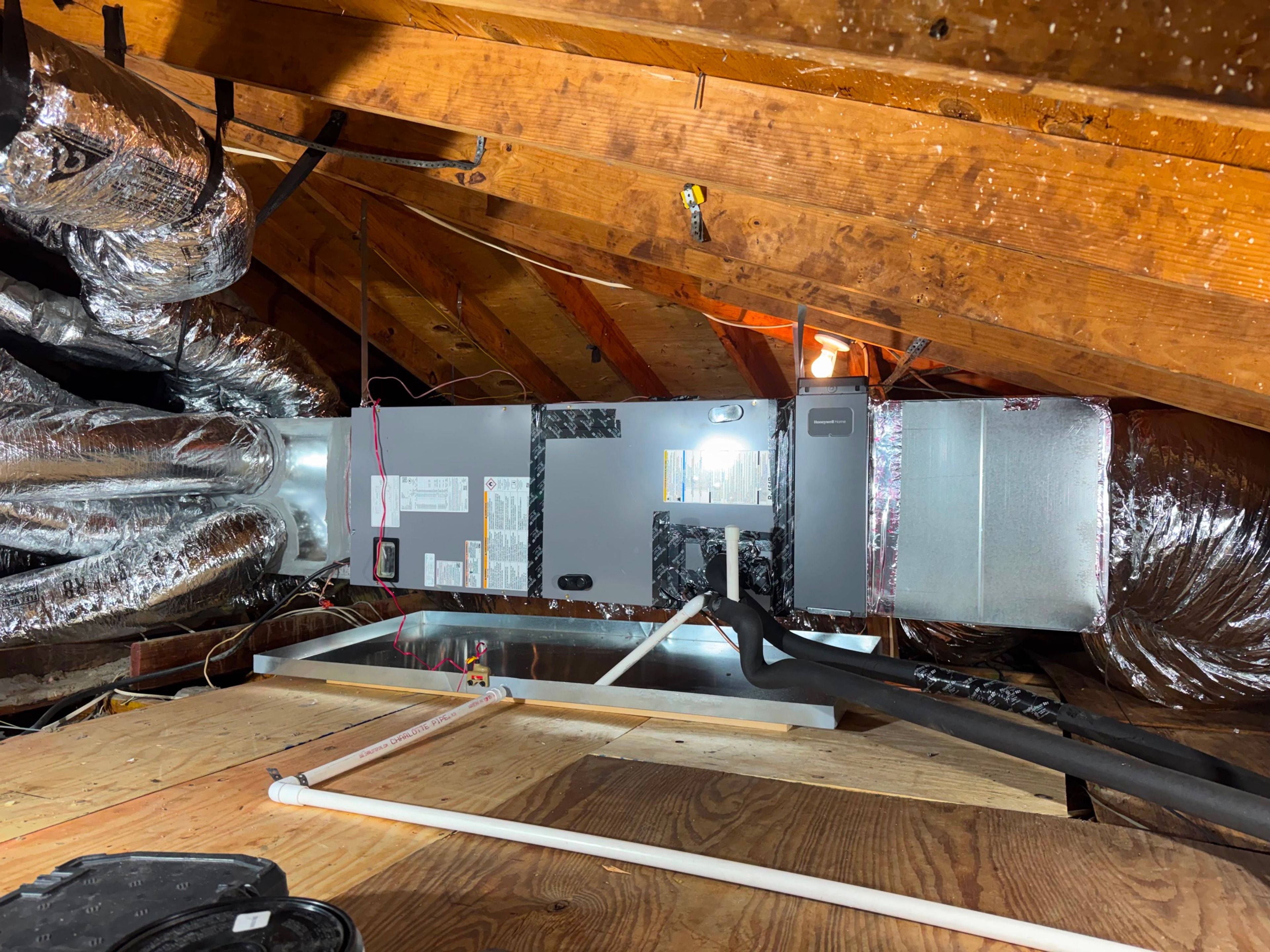 Attic air handler and insulated ductwork after a Taylor AC and Heat service visit