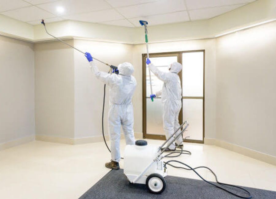 Technicians cleaning a commercial ceiling