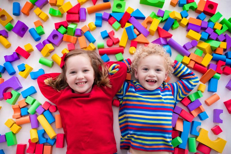 New Hampshire RFP Happy preschool children with colorful blocks shown for The Bid Lab's Featured Bid for a New Hampshire RFP.