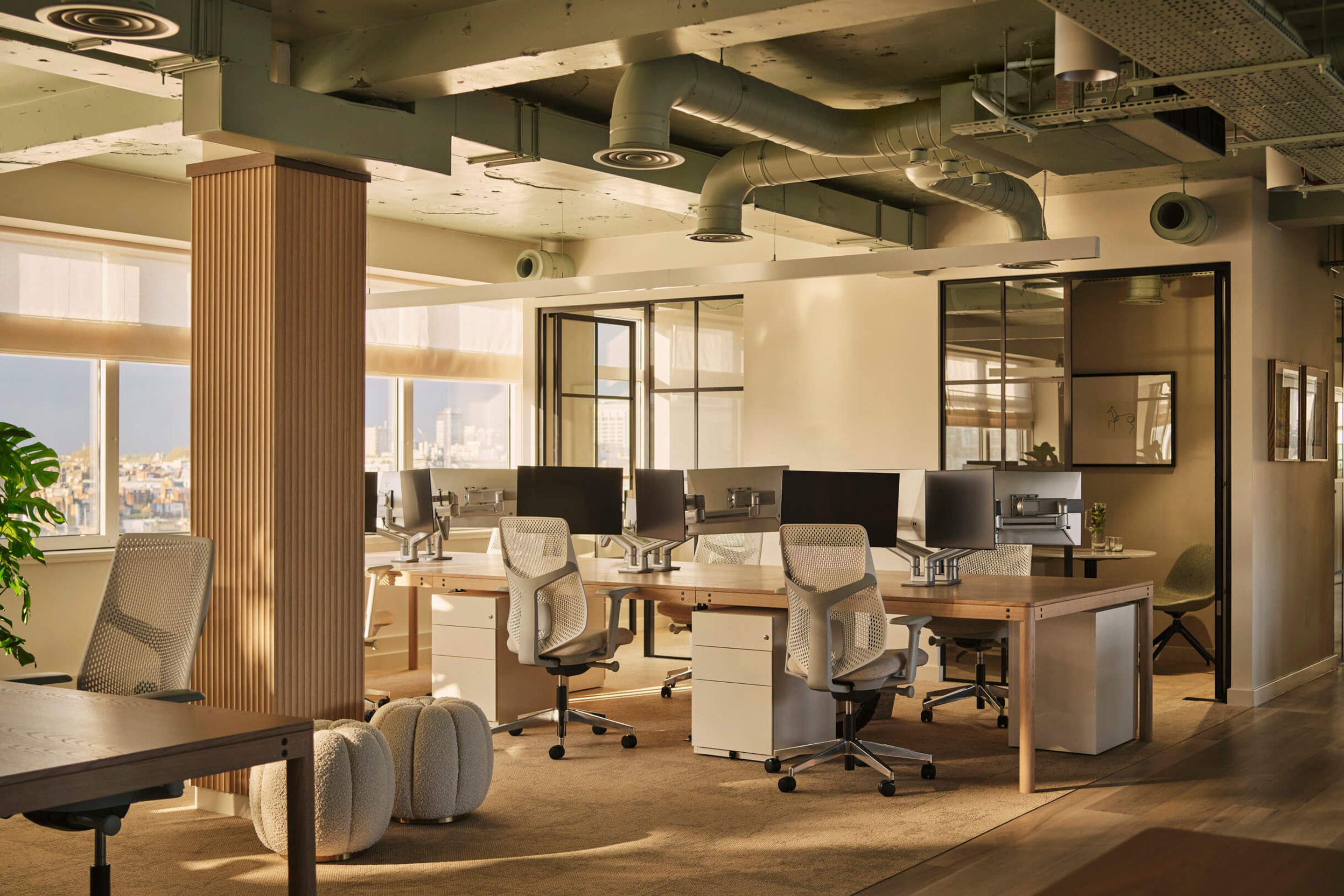 The Wigmore Private Office's open plan office space with a person walking through it.