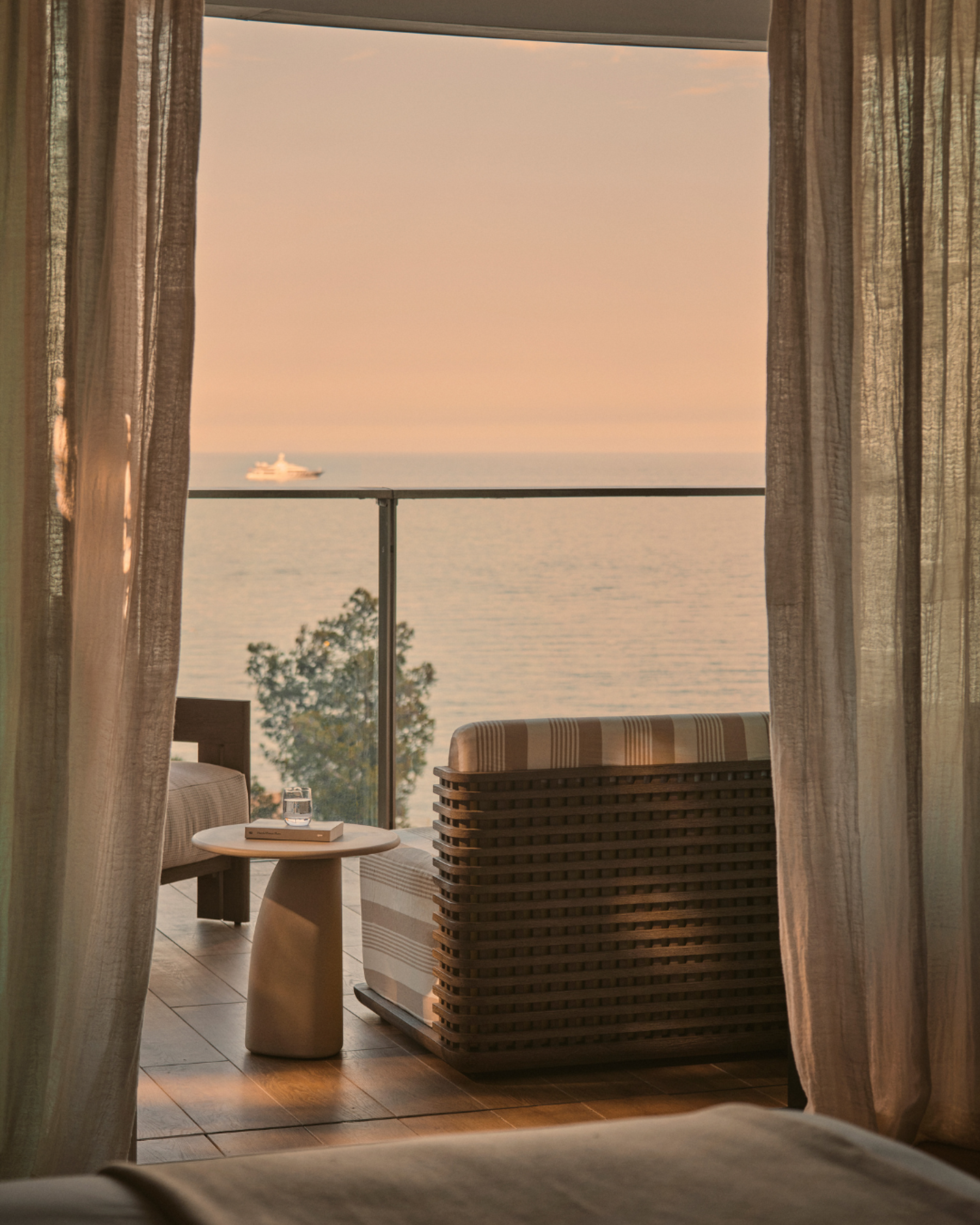 The Monaco Retreat's terrace overlooking the sea at sunset.