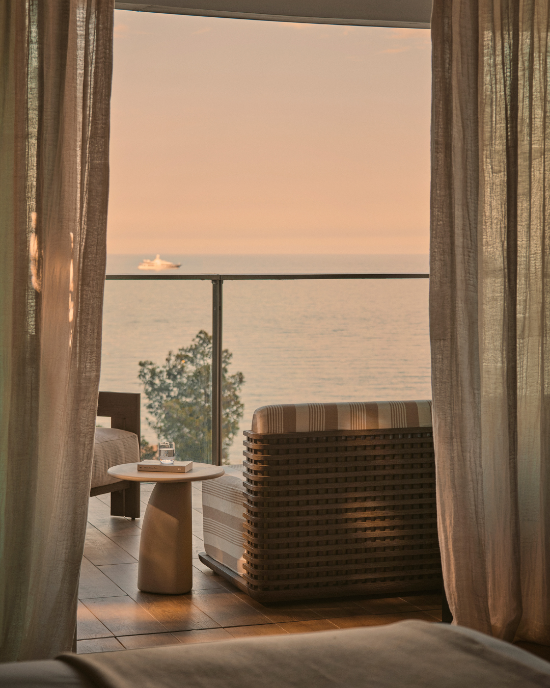 The Monaco Retreat's terrace overlooking the sea at sunset.