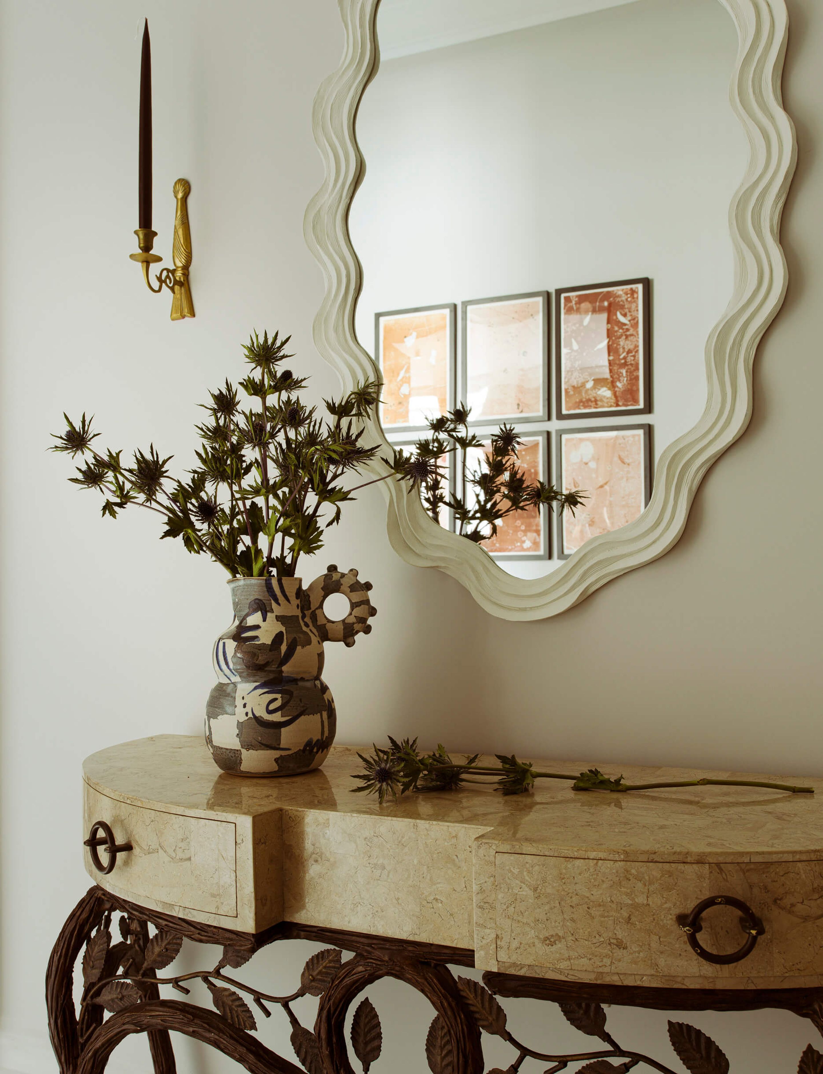Side table, mirror, and vase designed by Elicyon interior design studio