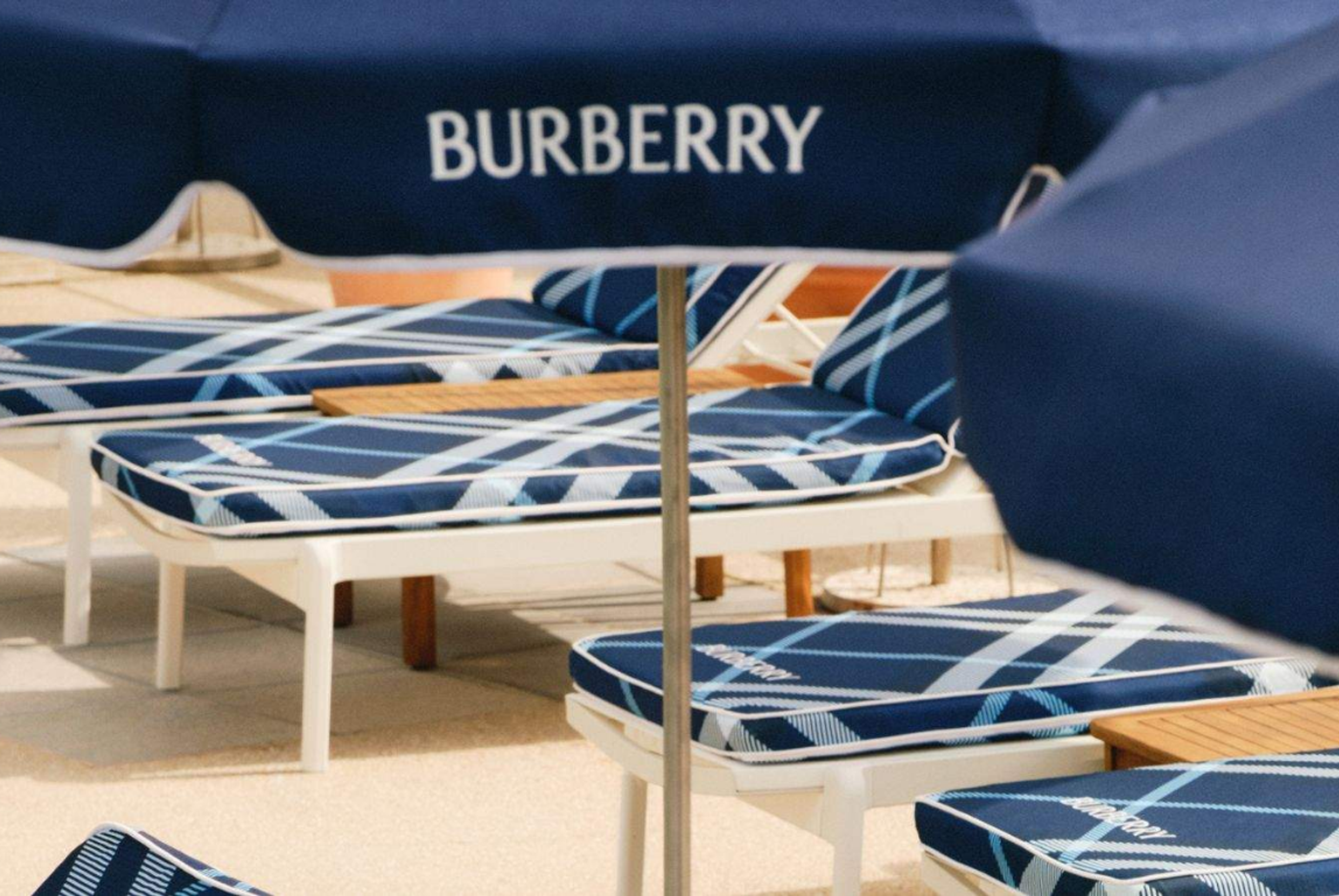 burberry logo on a luxury umbrella with beach chairs