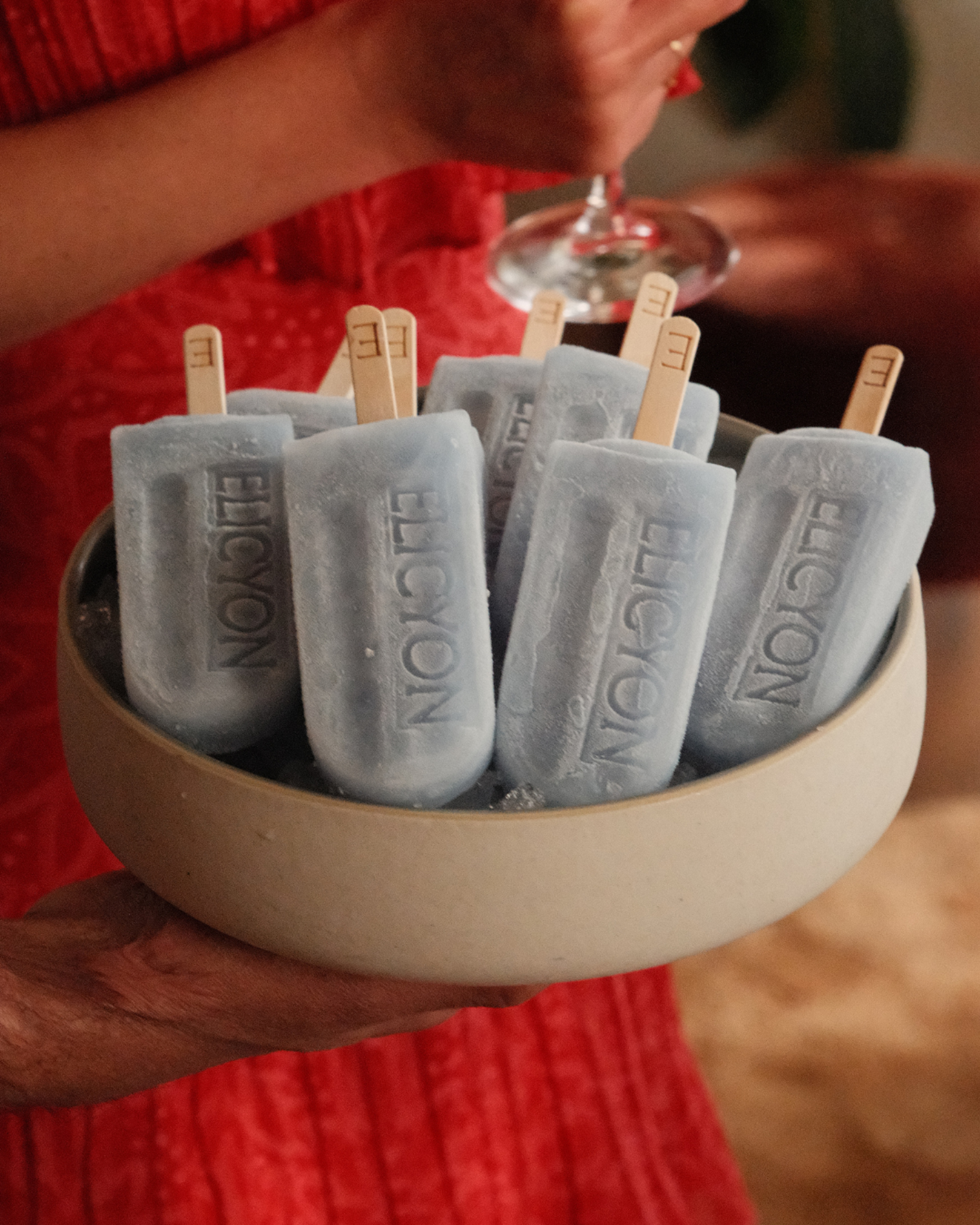 Elicyon-branded ice lollies served at a London interior design studio event, presented in a handcrafted ceramic bowl.